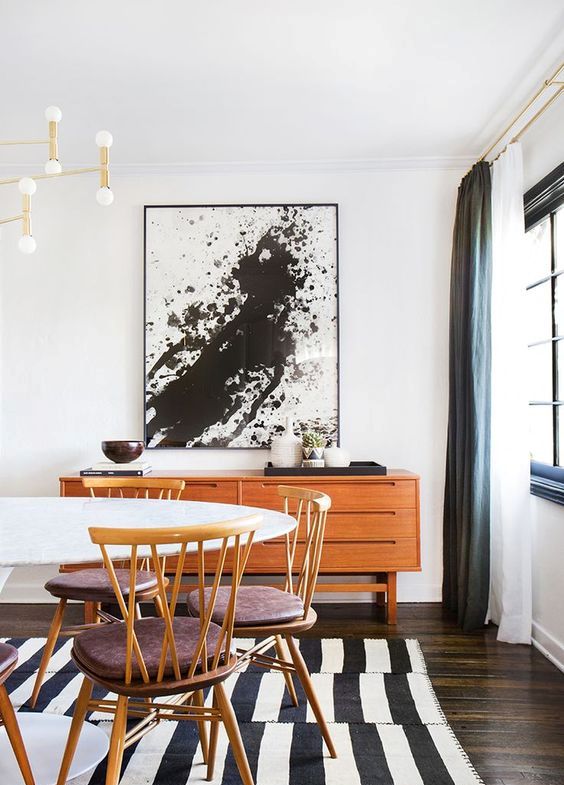 Bold Splatter Artwork Anchors a Warm Wood Credenza