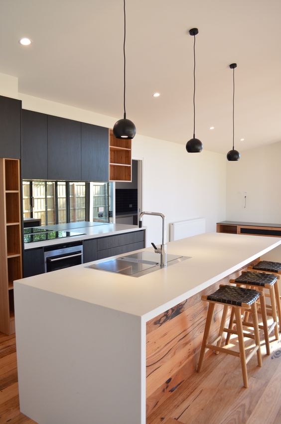 Natural Wood Paneling and Leather-Wrapped Stools for Island Dining