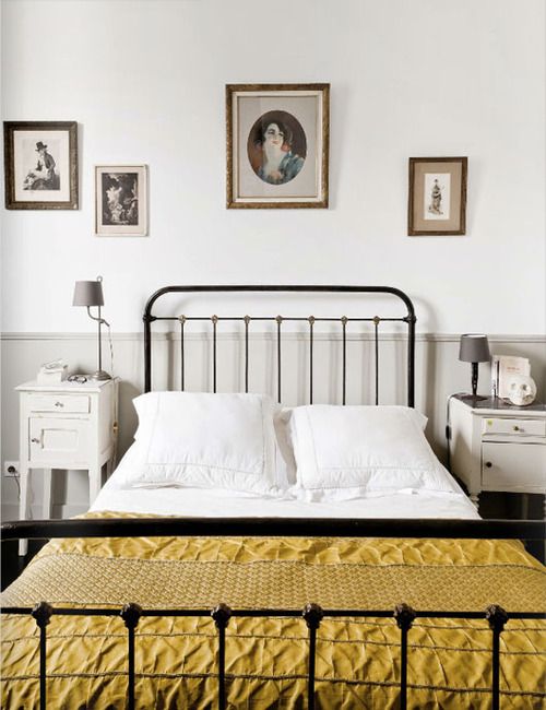 Gallery Wall of Vintage Portraits Above Bed