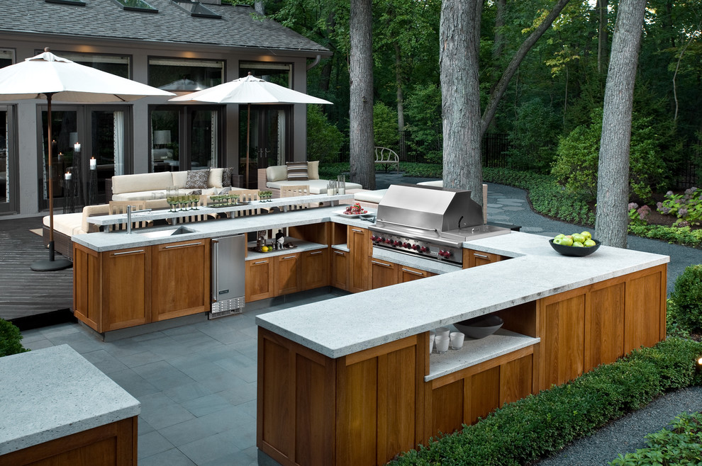 Outdoor Kitchen With Integrated Grill and Wood Cabinetry