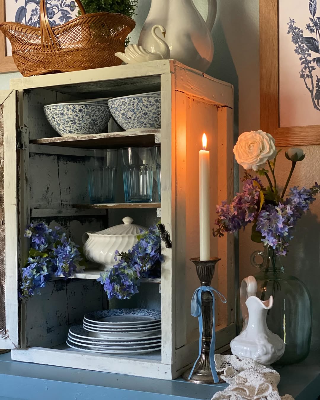Distressed Cabinet Displays Blue and White Dinnerware