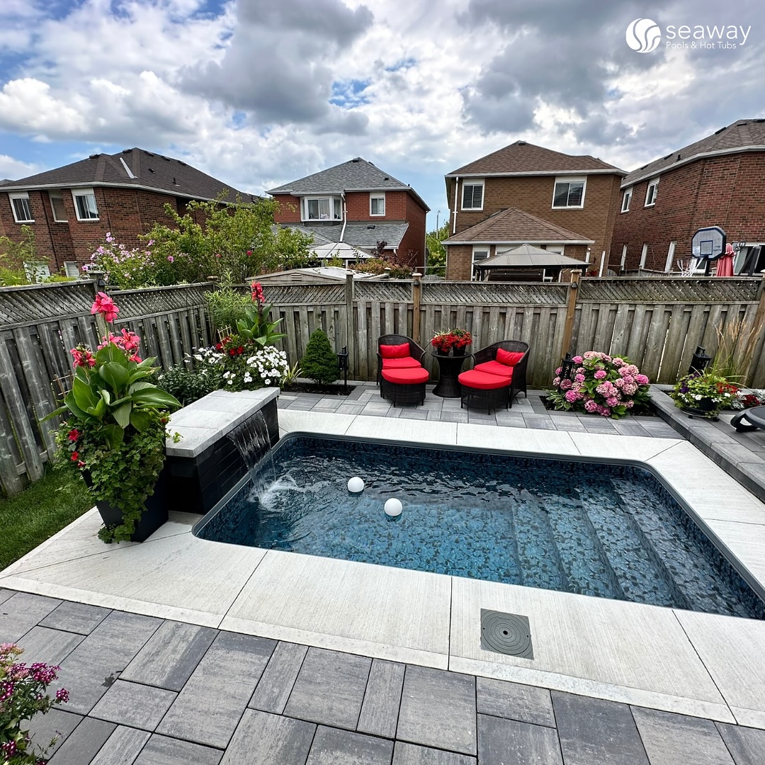 Compact Pool With Integrated Waterfall and Built-In Seating