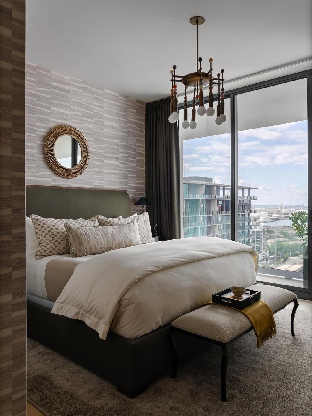 Round Rattan Mirror Adds Natural Texture Above the Bed