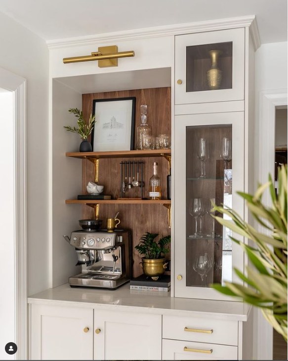 Brass Picture Light Illuminates Artwork Above Shelves