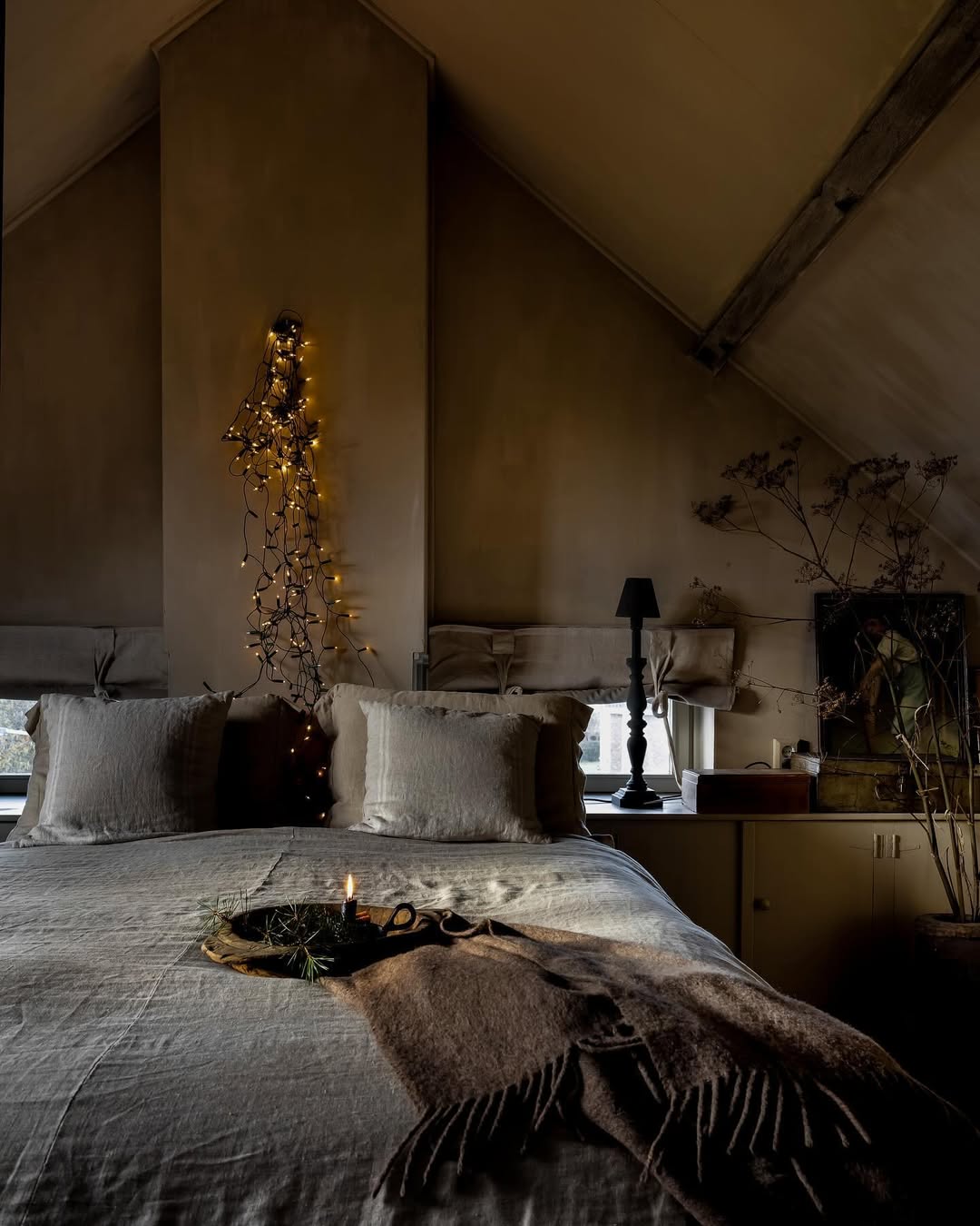 Twinkle Lights Drape Down a Sloping Wall