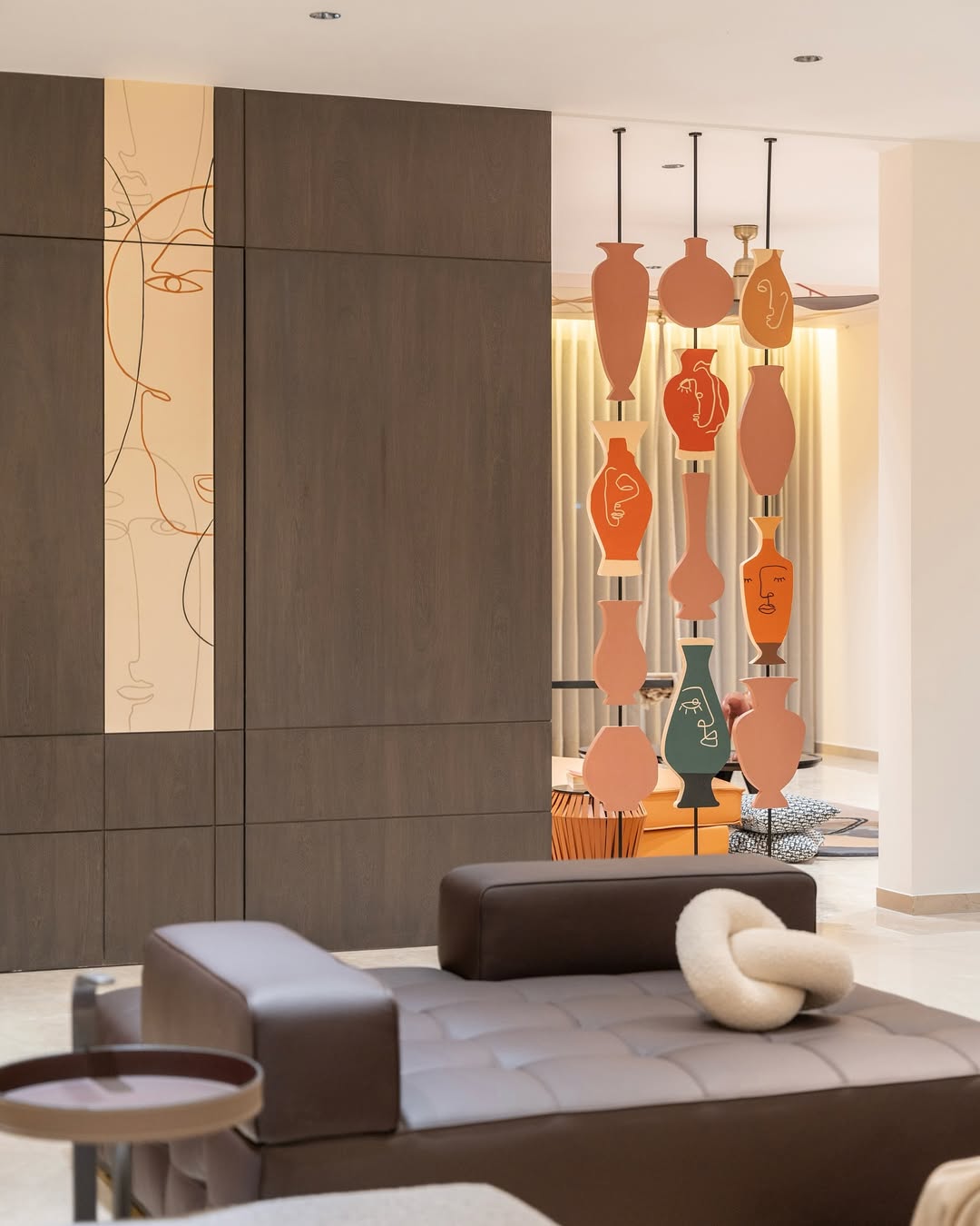 Hanging Vases With Abstract Faces Create a Playful Divider