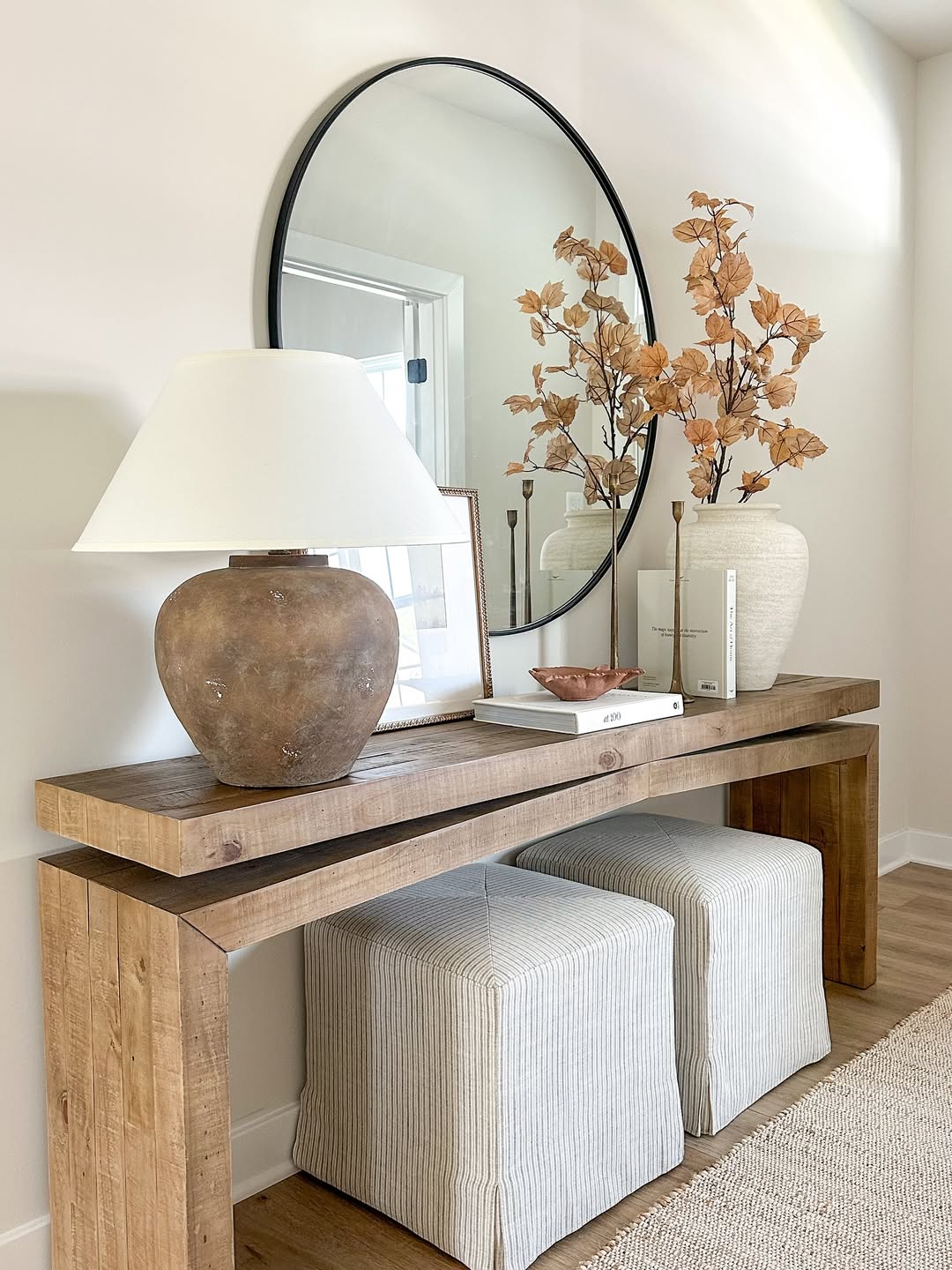 Tuck Striped Ottomans Under a Console Table for Extra Seating