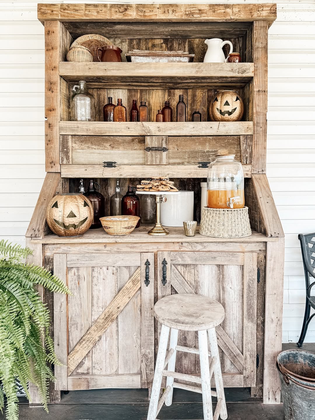 Rustic Wooden Hutch Displays Seasonal Decorations and Drinks