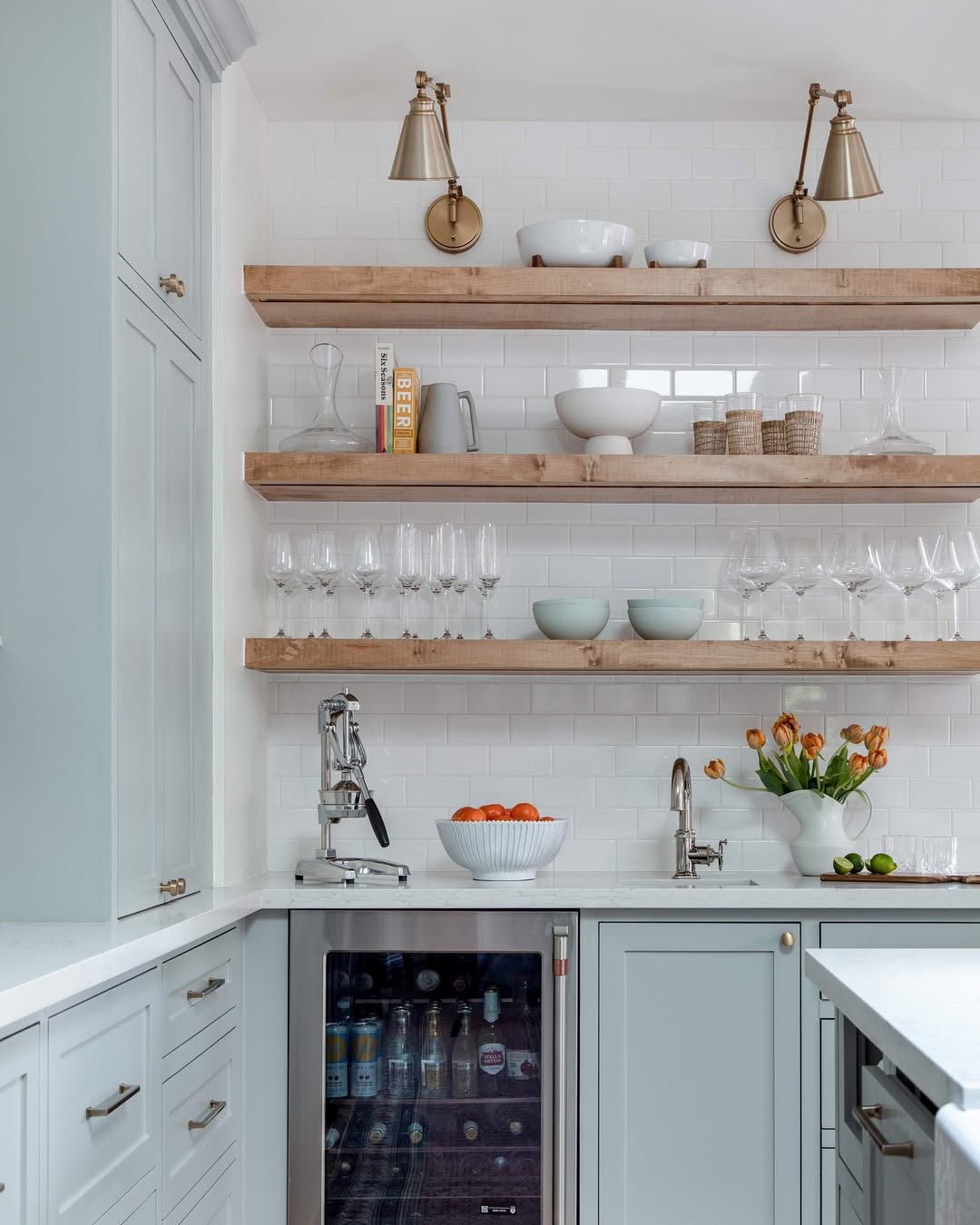 Open Shelves With Brass Sconces Add Warmth