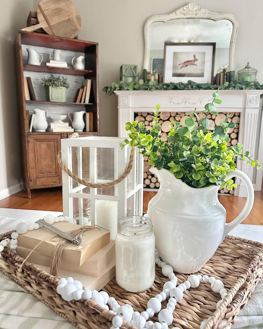 White Pitcher with Greenery on Woven Tray