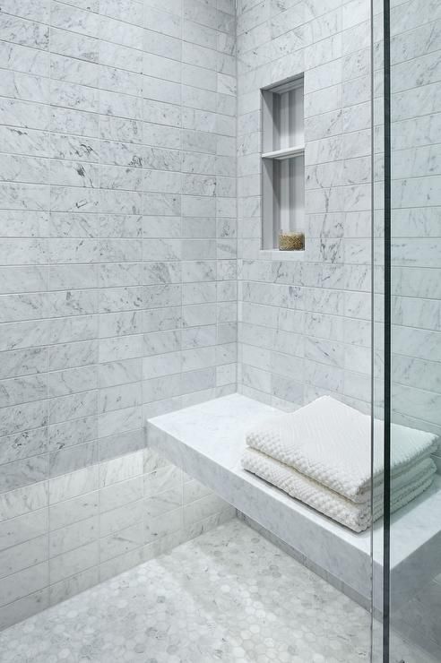 Marble Ledge Seat With Stacked Towels for a Spa-Like Feel