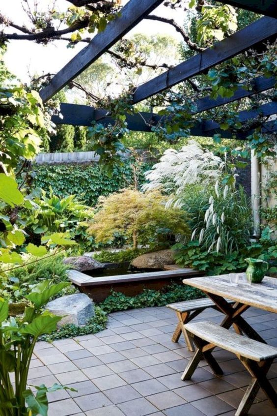 Pergola With Cascading Vines Creates A Lush Outdoor Room