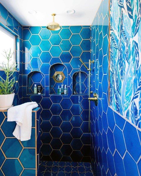 Blue Hex Tile Shower with Gold-Trimmed Niches