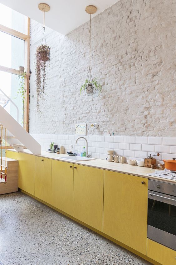 Hanging Planters Add Greenery Above White Brick Walls