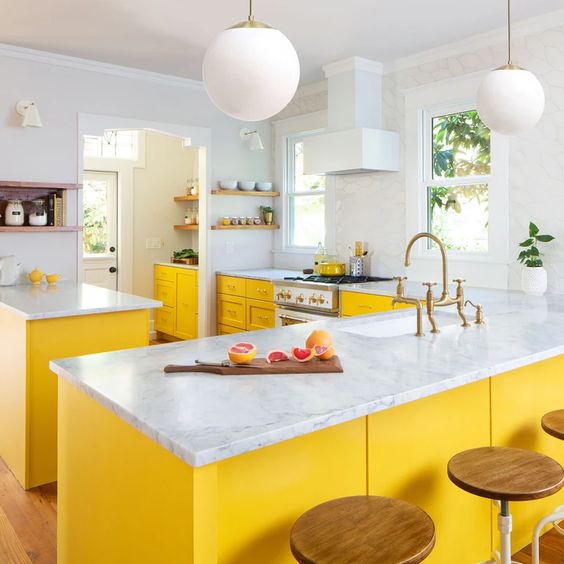 Anchor Your White Kitchen with a Bold Yellow Island