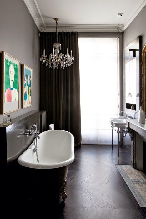 Two Framed Art Pieces Add Color Above the Bathtub Ledge