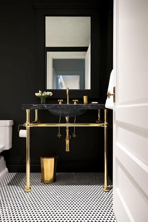 Black Marble Vanity with Gold Legs Creates a Dramatic Focal Point