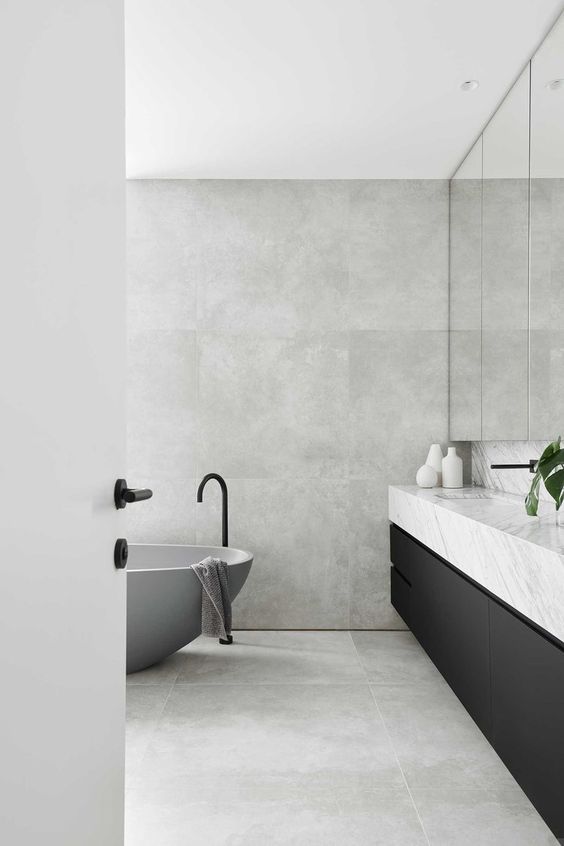Matte Grey Tub and Black Fixtures Create a Dramatic Focal Point