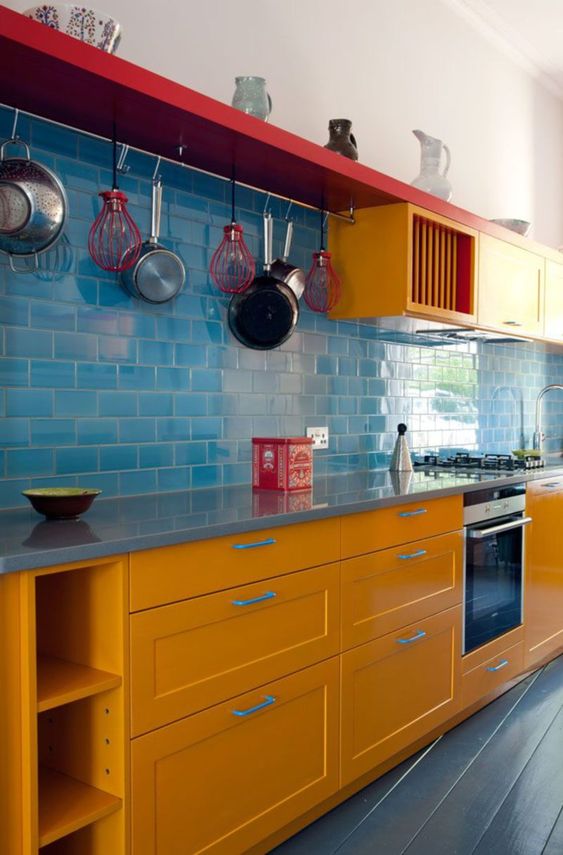 Red Shelf With Hanging Pots and Whisks