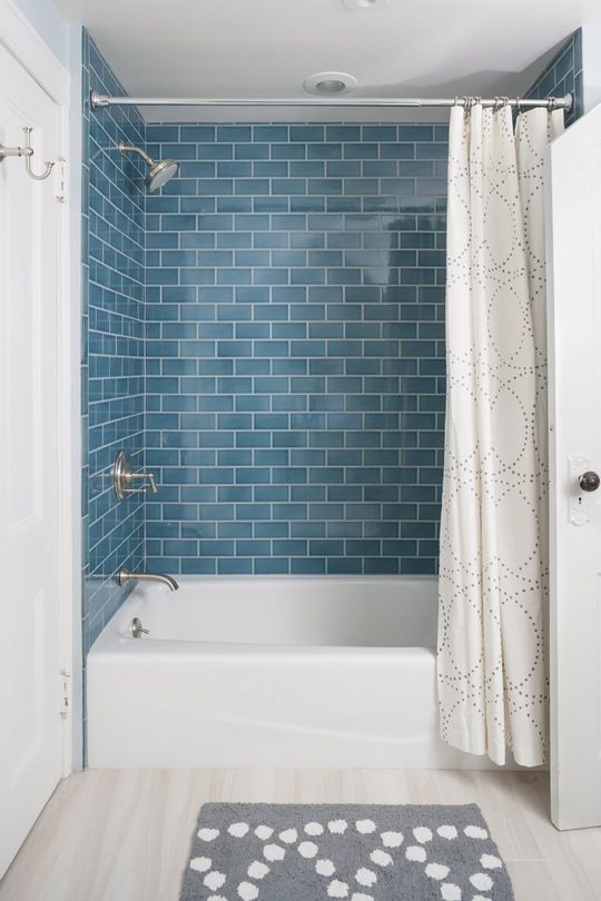 Deep Teal Subway Tile Creates a Watery Shower Enclosure