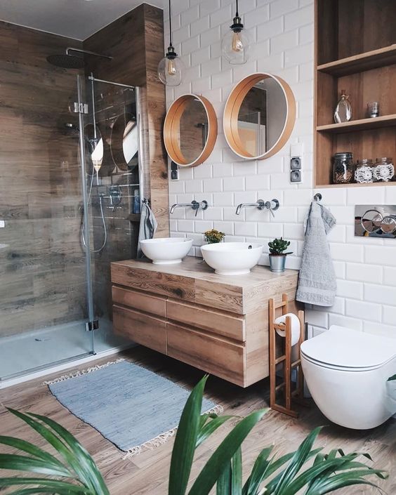 Round Mirrors With Wood Frames Soften the Vanity Area