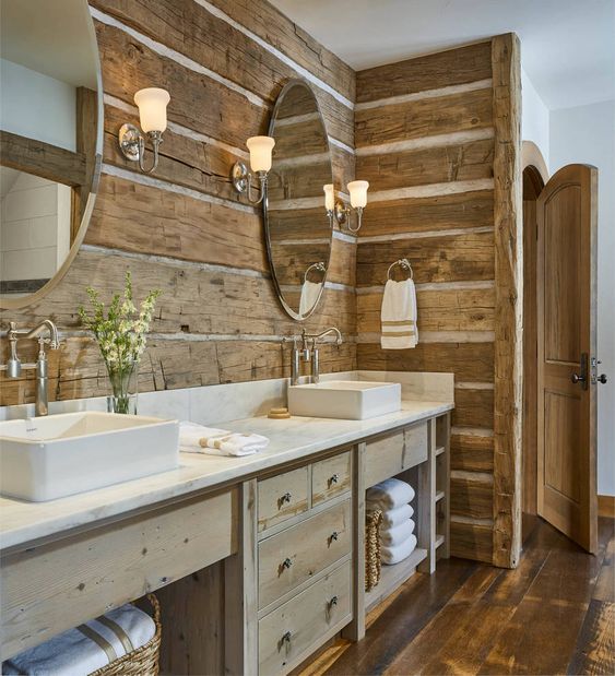 Oval Mirrors Reflect Light and Wood Tones on Log Walls