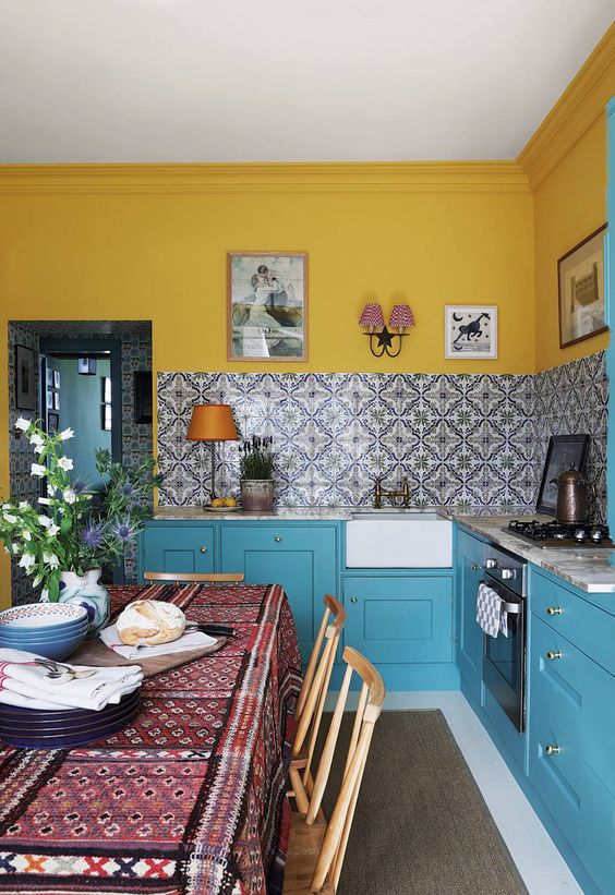 Patterned Tile Backsplash Adds Artistic Flair Above Blue Cabinets