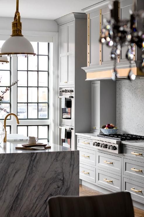 Gold Bar Pulls Add Warmth to Light Gray Cabinets