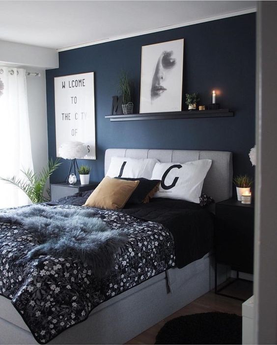 Narrow Shelf Displays Art and Greenery Above the Bed