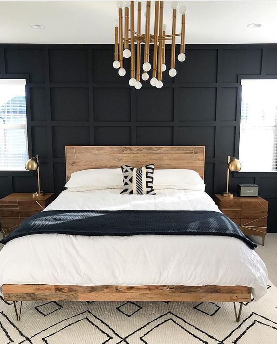 Paneled Black Wall Adds Dramatic Depth Behind a Wooden Bed