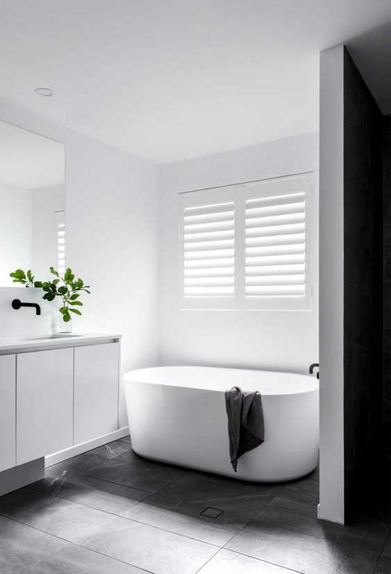White Freestanding Tub with Dark Towel Adds Subtle Contrast