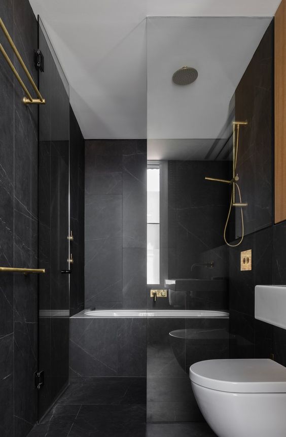 Brass Towel Bars Add Warmth To Black Marble Walls