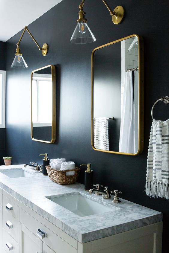 Symmetrical Gold Mirrors Frame a Double Vanity