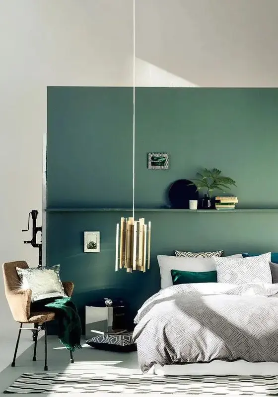 Green Accent Wall Creates a Moody Backdrop for Bedside Decor