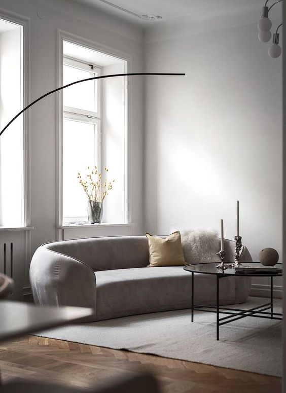 Layer Textures with Contrasting Throw Pillows on a Curved Sofa
