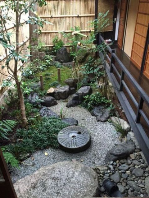 Circular Millstone Adds Rustic Charm to Gravel Garden