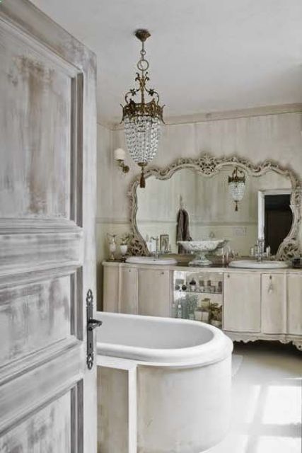 Ornate Mirror Frames a Double Vanity with Open Shelving