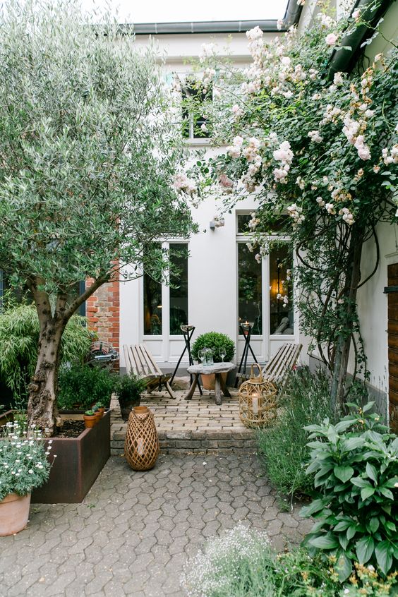 Woven Lanterns Add Soft Ambiance To A Cozy Courtyard