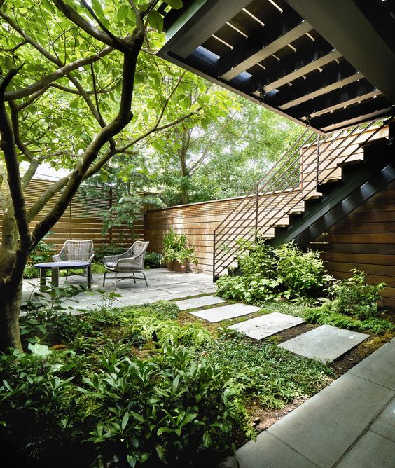 Stone Stepping Stones Create A Natural Path Through Dense Greenery