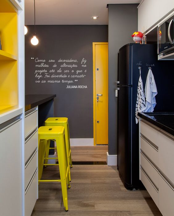 Bright Yellow Stools Add a Pop of Color to a Dark Kitchen