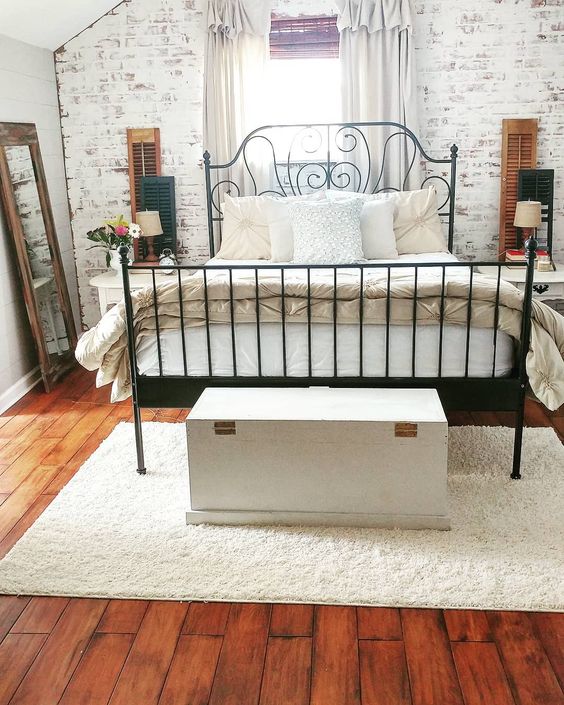 White Storage Chest Adds A Rustic Anchor To The Bed