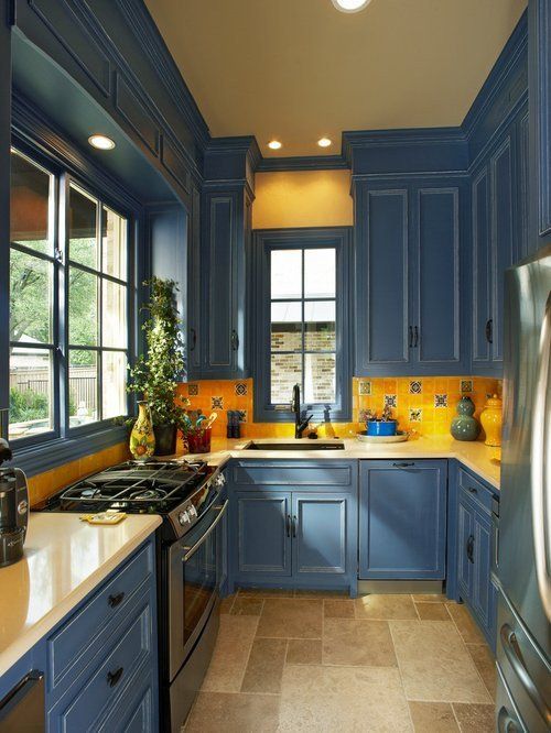 Yellow Tile Backsplash Adds Warmth Above Blue Cabinets