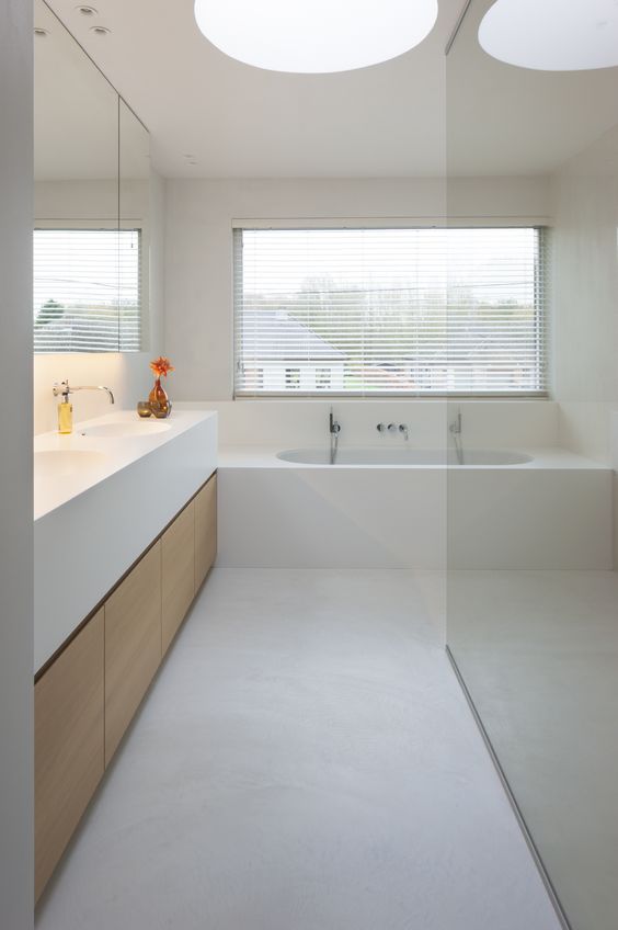 Light Wood Cabinetry Offers a Warm Contrast to White Vanity