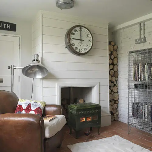 Large Industrial Clock Adds a Vintage Focal Point Above the Fireplace