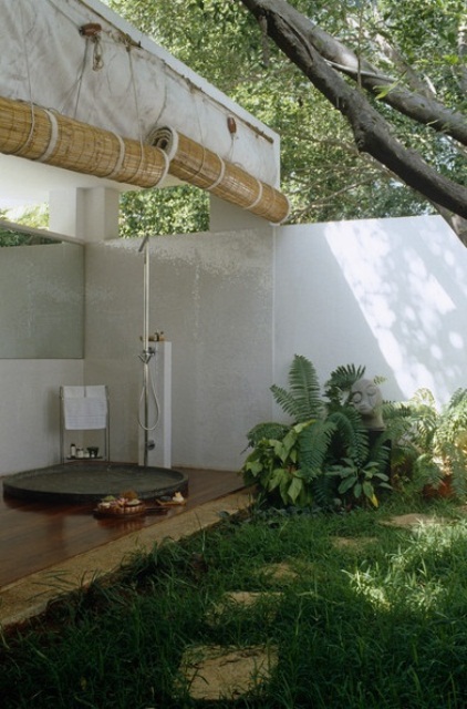 Round Wooden Deck with Dark Shower Basin Creates a Zen Zone