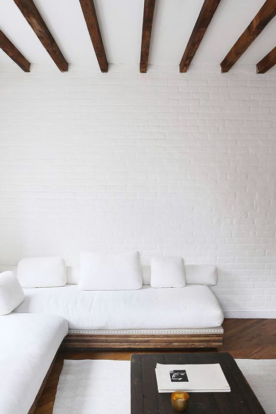 Exposed Wooden Beams Contrast with White Brick