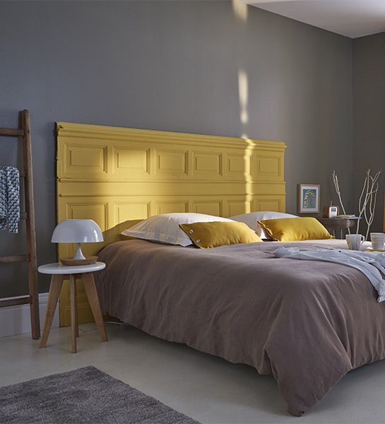 Repurposed Door Panel Creates a Bold Yellow Headboard