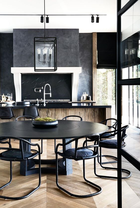 Anchor Your Dining Space with a Round Black Table and Sculptural Chairs