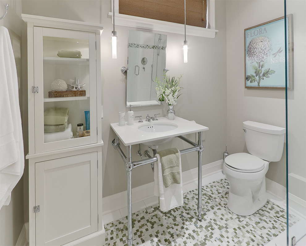 White Cabinet With Glass Doors Displays Folded Towels and Decor