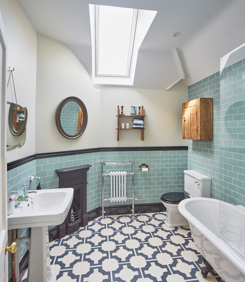 Patterned Floor Tiles Ground the Bathroom's Aqua Walls